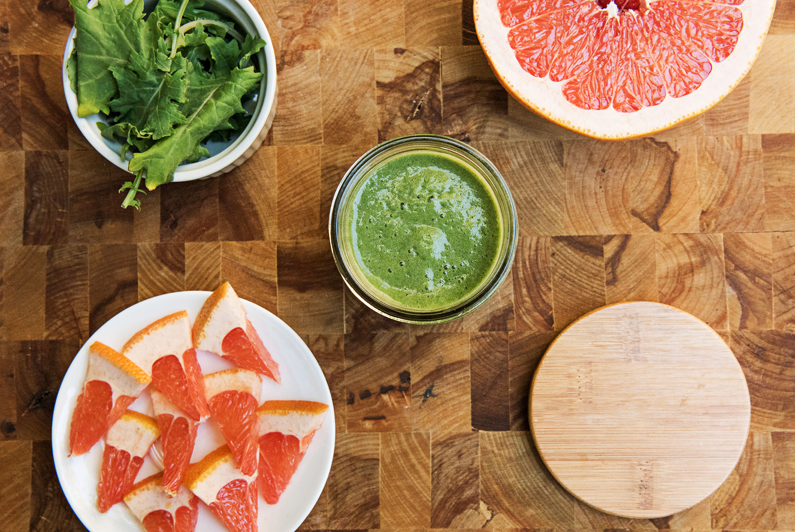 Vibrant green and grapefruit smoothie featuring a mix of fresh, healthy ingredients.