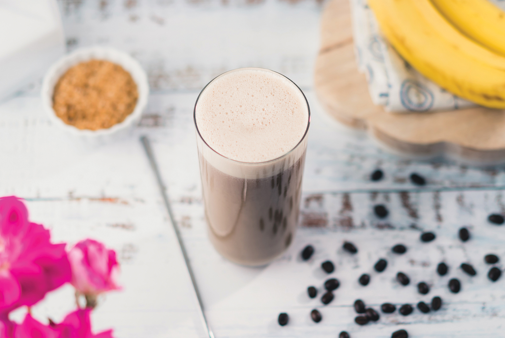 glass of frosty coffee and banana smoothie