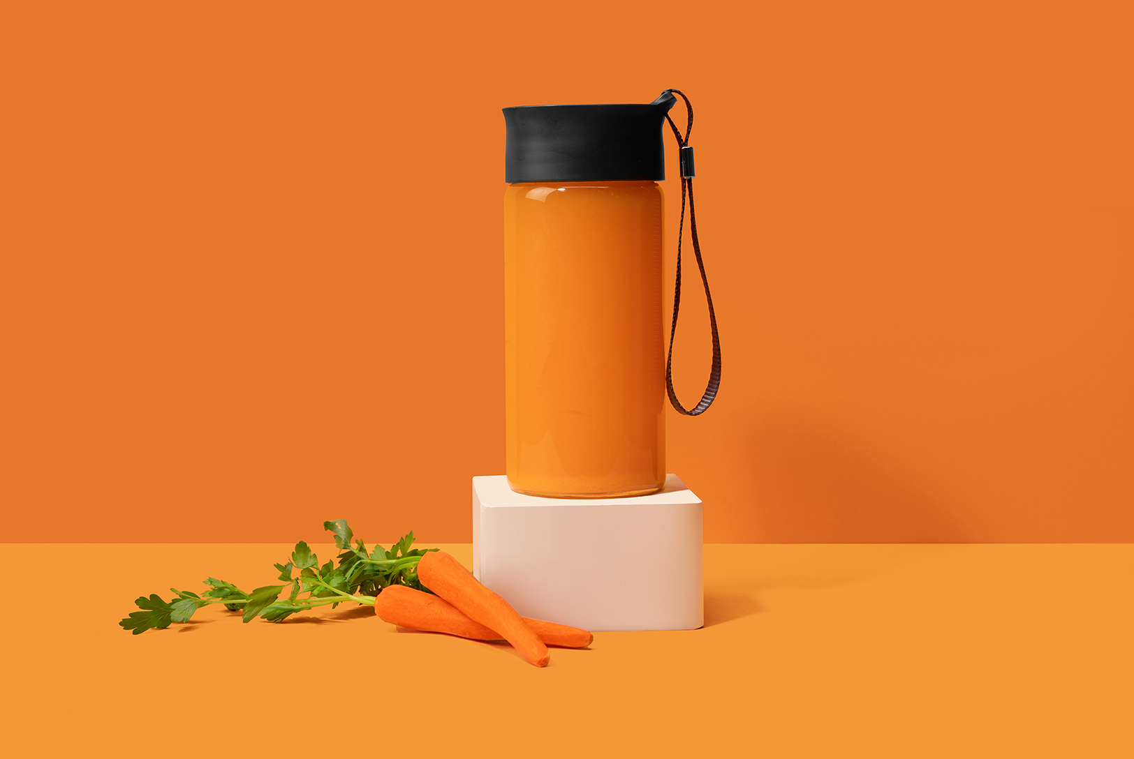 bottle of carrot and apple juice with fresh carrots