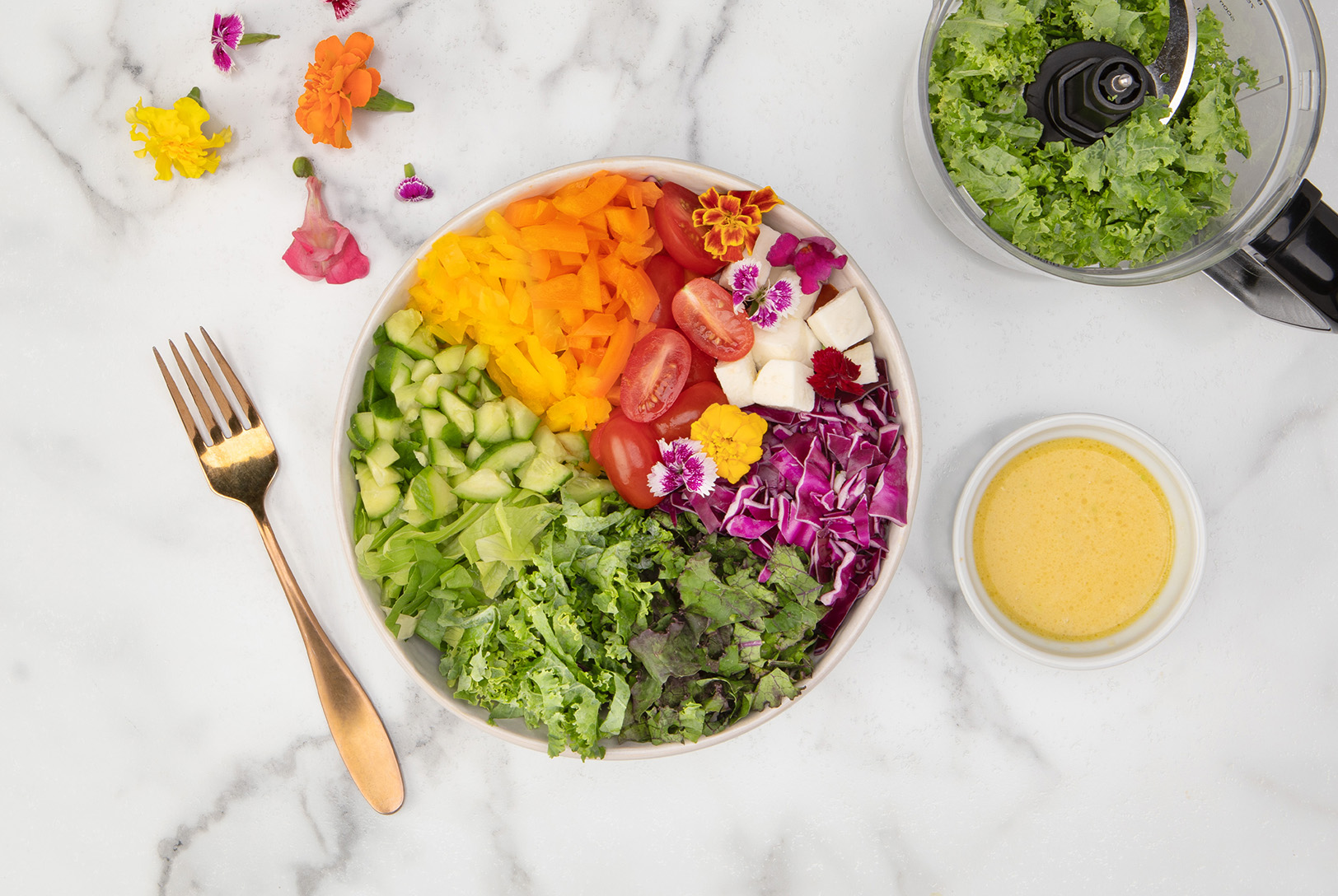 bowl of salad with tomatoes, red cabbage, peppers, cucumber, and lemony dressing
