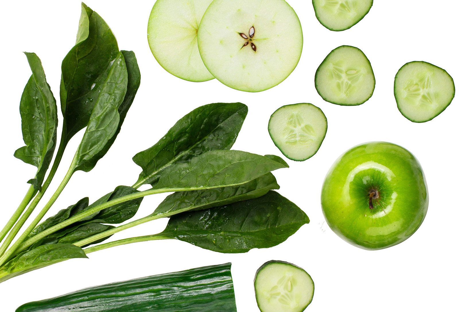 flat lay of spinach, green apples, and cucumber