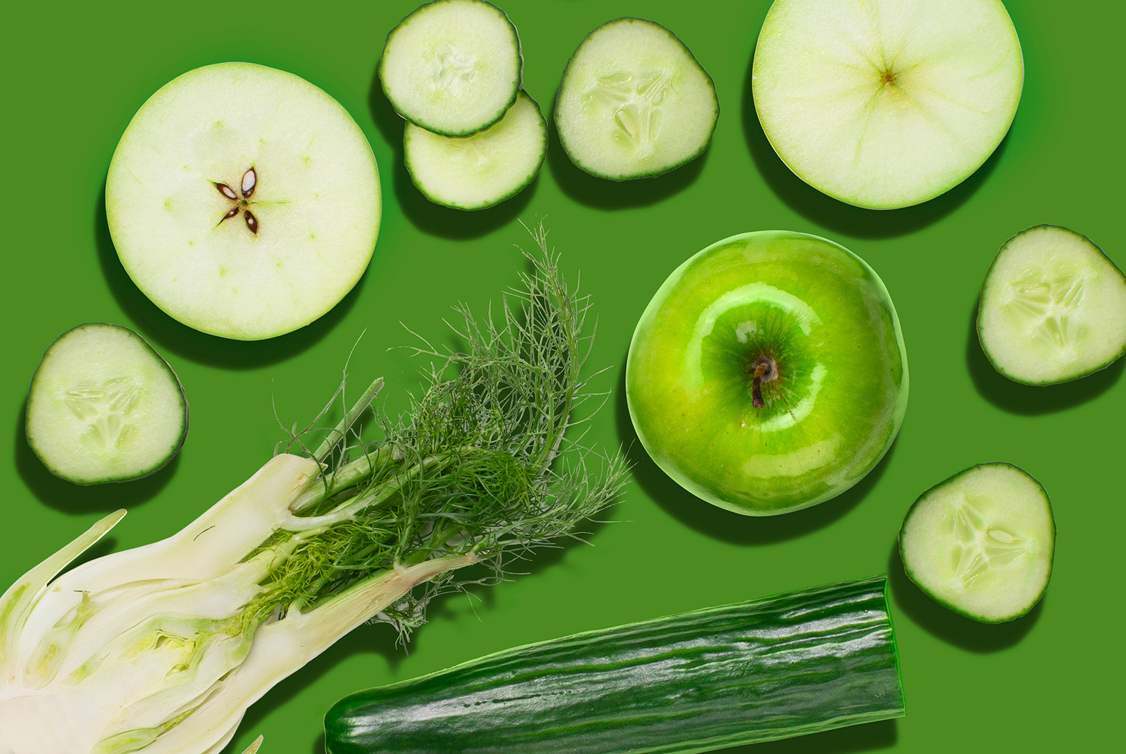 green apple, fennel, and cucumber on green background