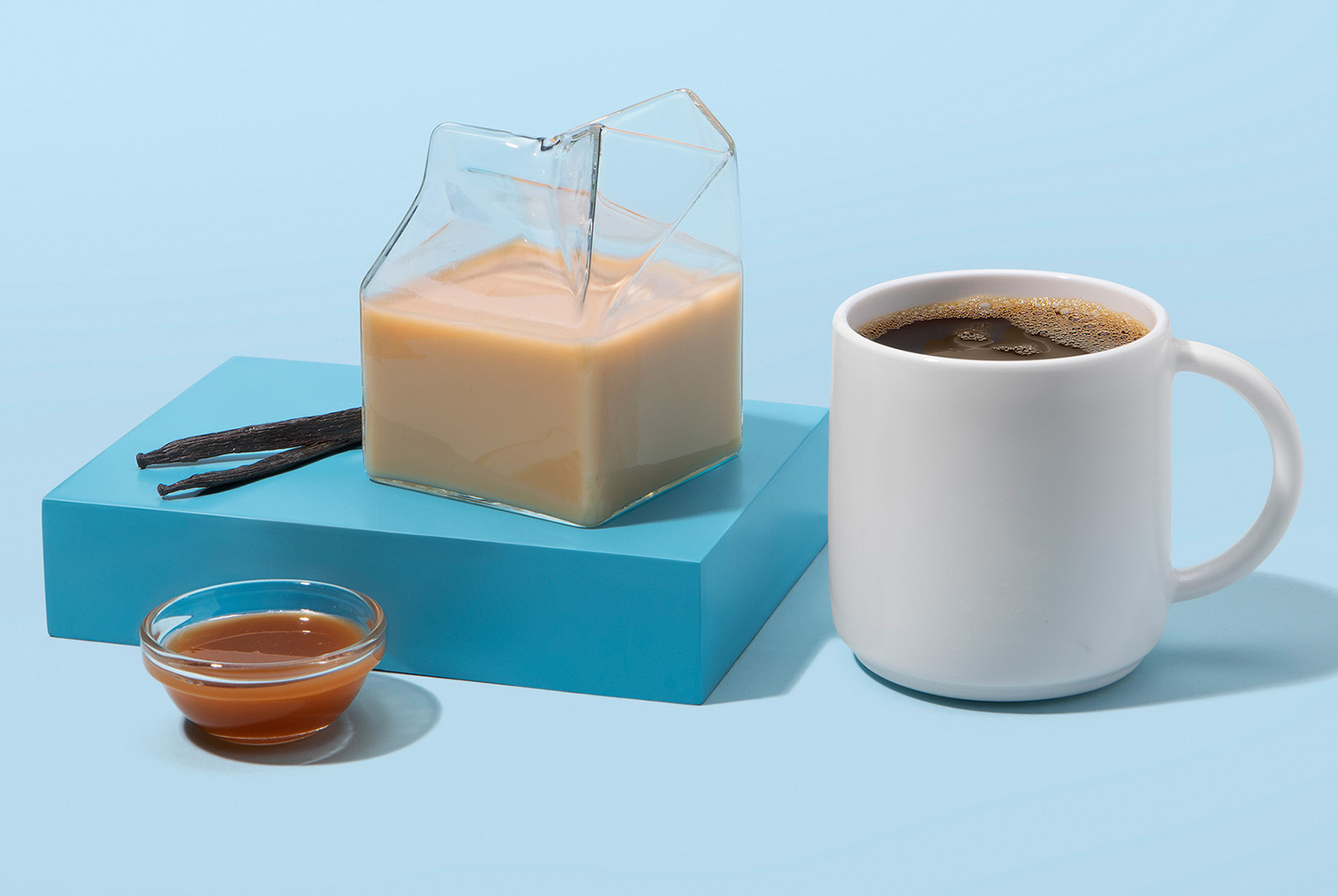 homemade caramel creamer next to mug of coffee