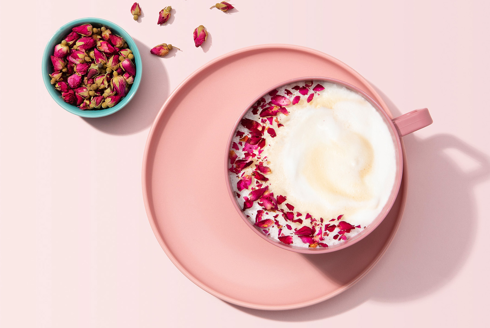 mug of rose latte made with rose milk and dried rose petals