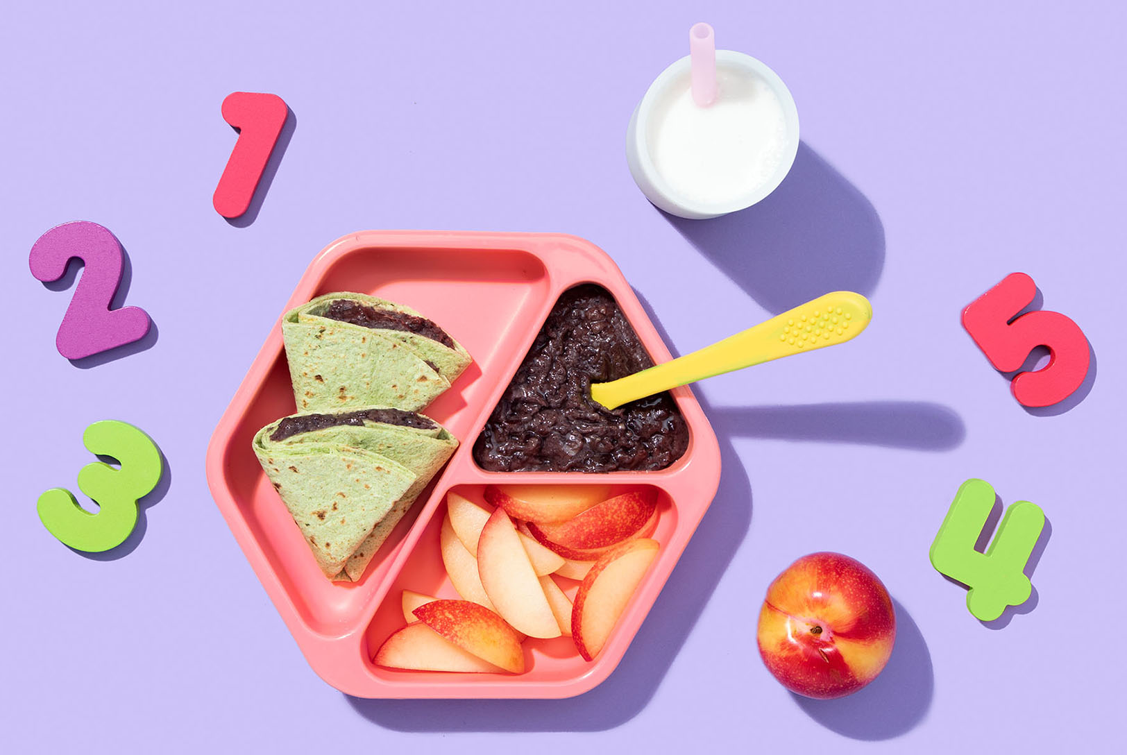 Black bean quesadilla with black bean puree, sliced nectarine and a glass of milk