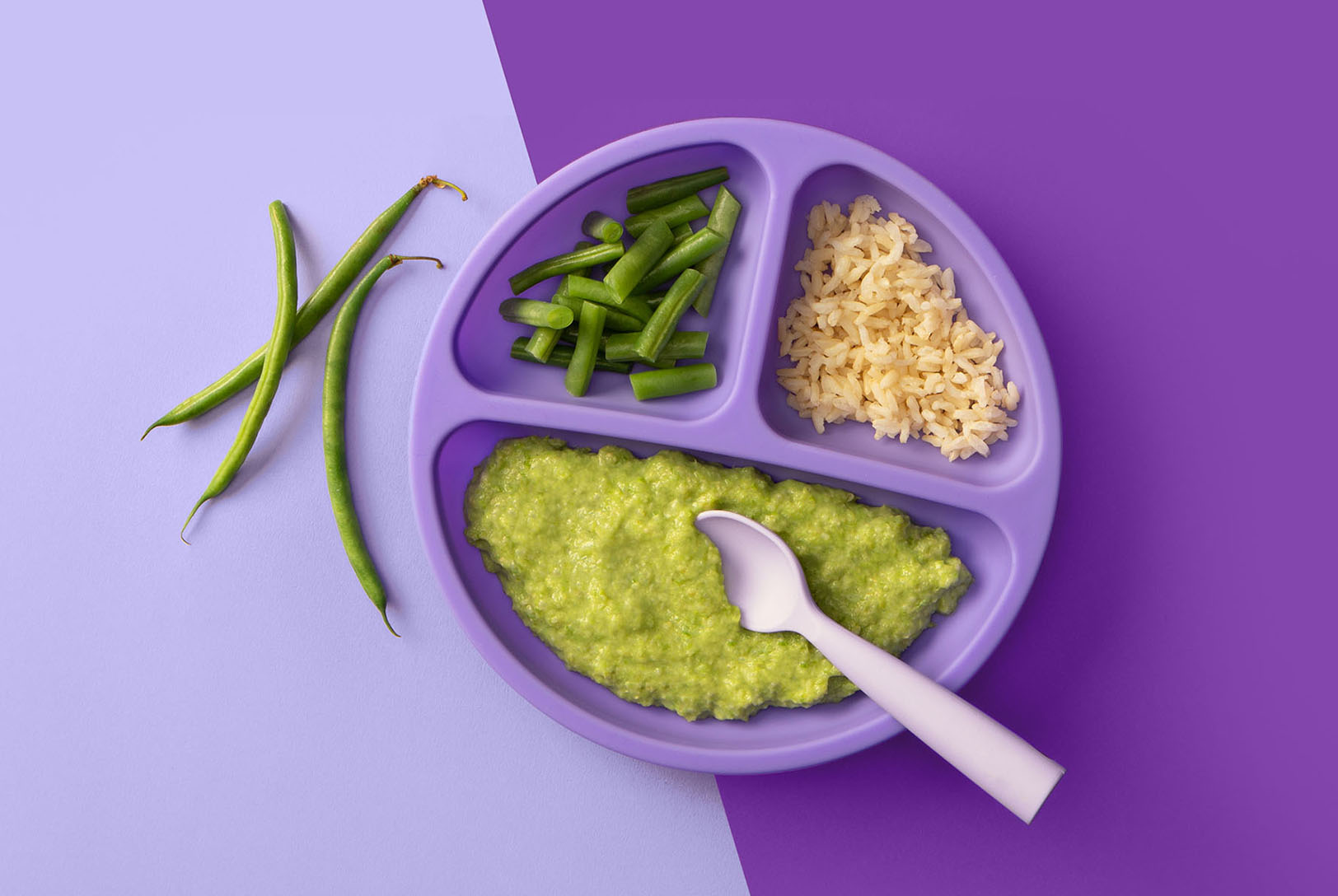 Plate of pureed green beans and rice with steamed green beans and rice