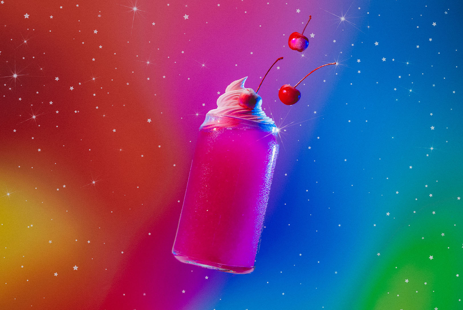 A bright pink Libra drink in a clear glass with whipped cream and cherries, set against a colorful, starry background.
