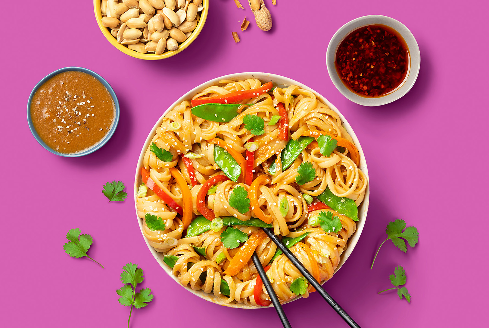 egg noodles topped with sesame sauce and garnished with herbs